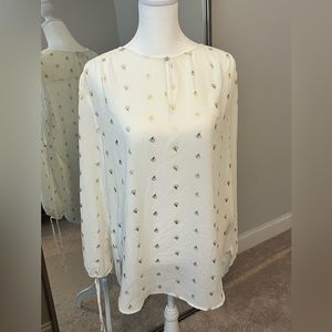 Limited blouse with keyhole neck and open arm detail